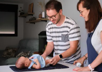 two person teasing an infant