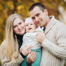 Happy family with baby outdoors