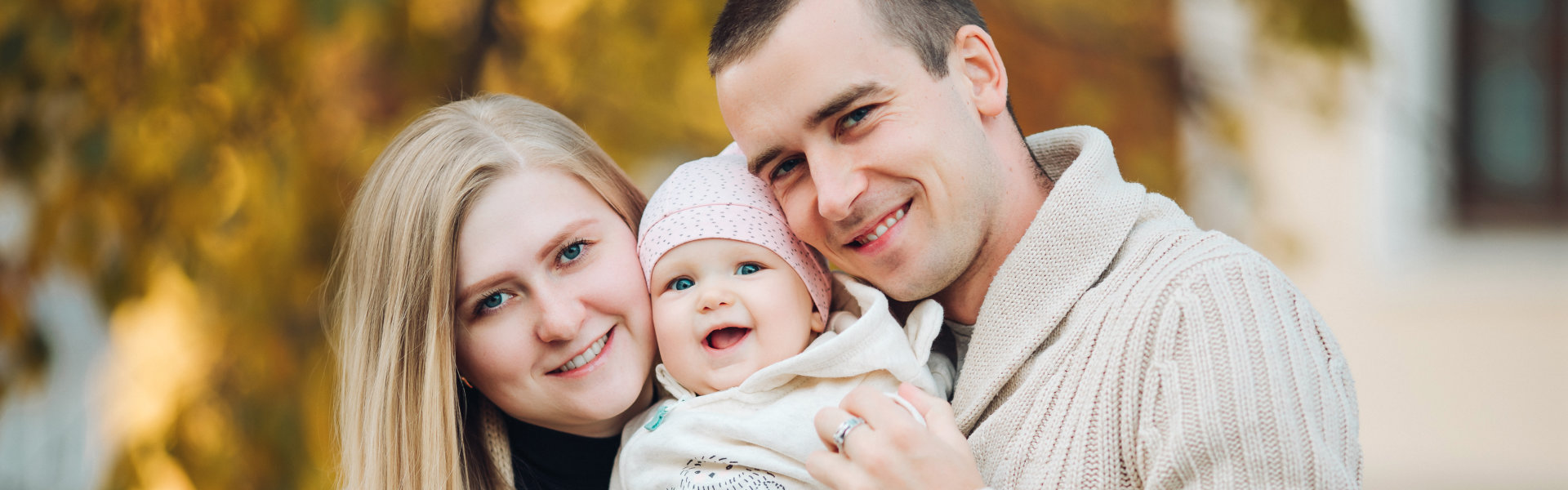 Happy family with baby outdoors