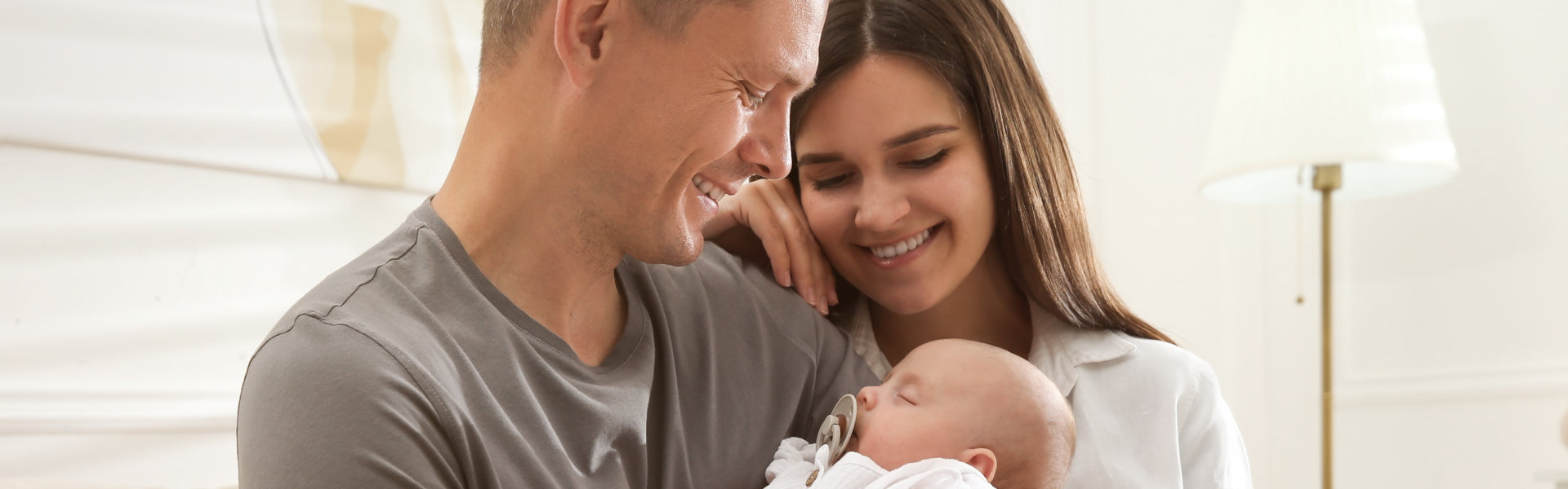 Parents holding sleeping baby