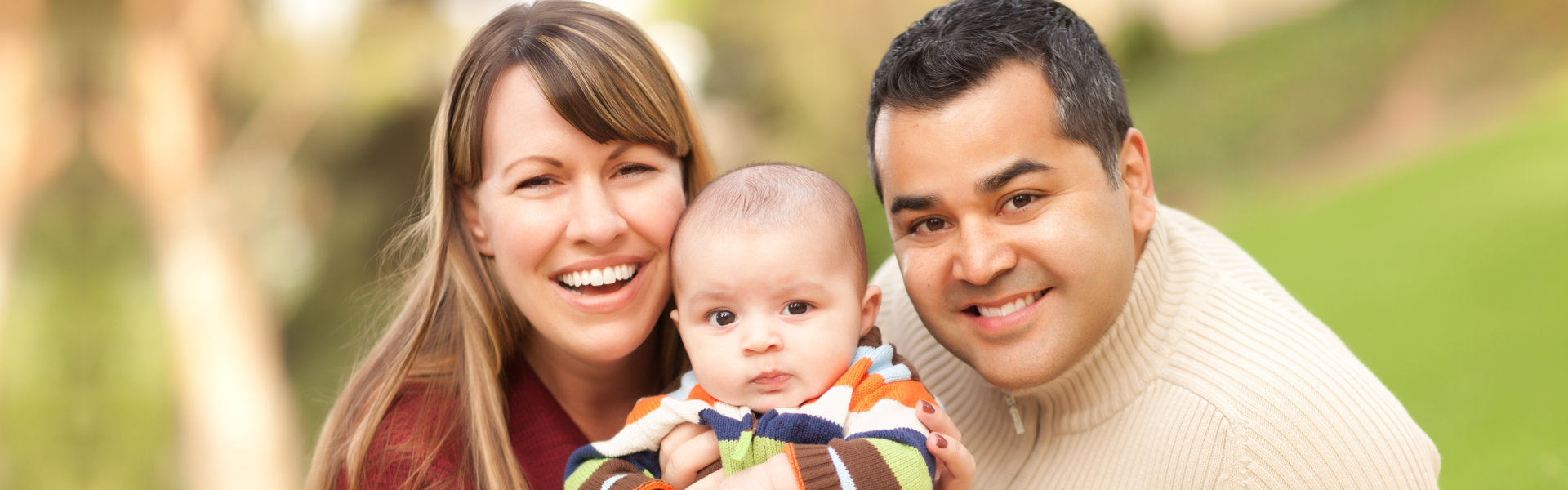Happy family with baby outdoors