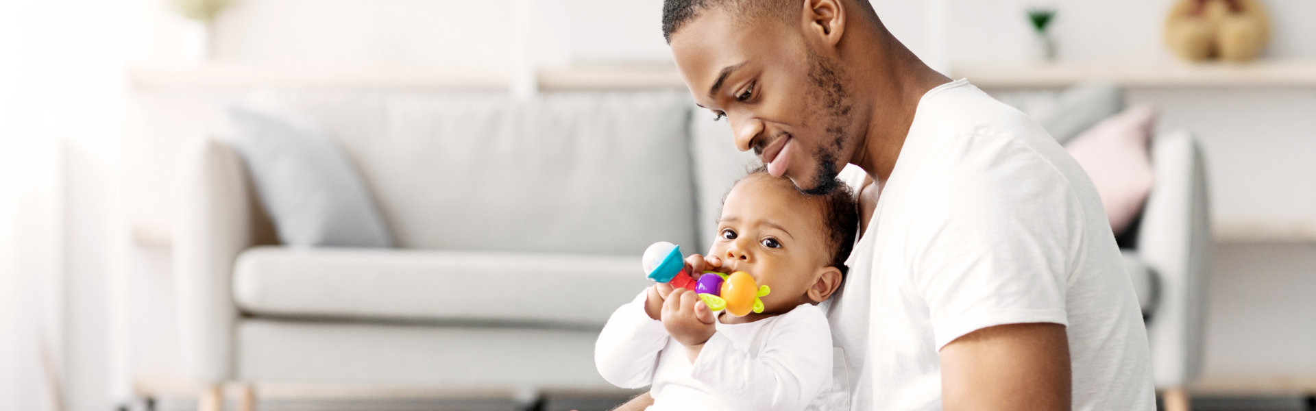 Father smiling while holding baby